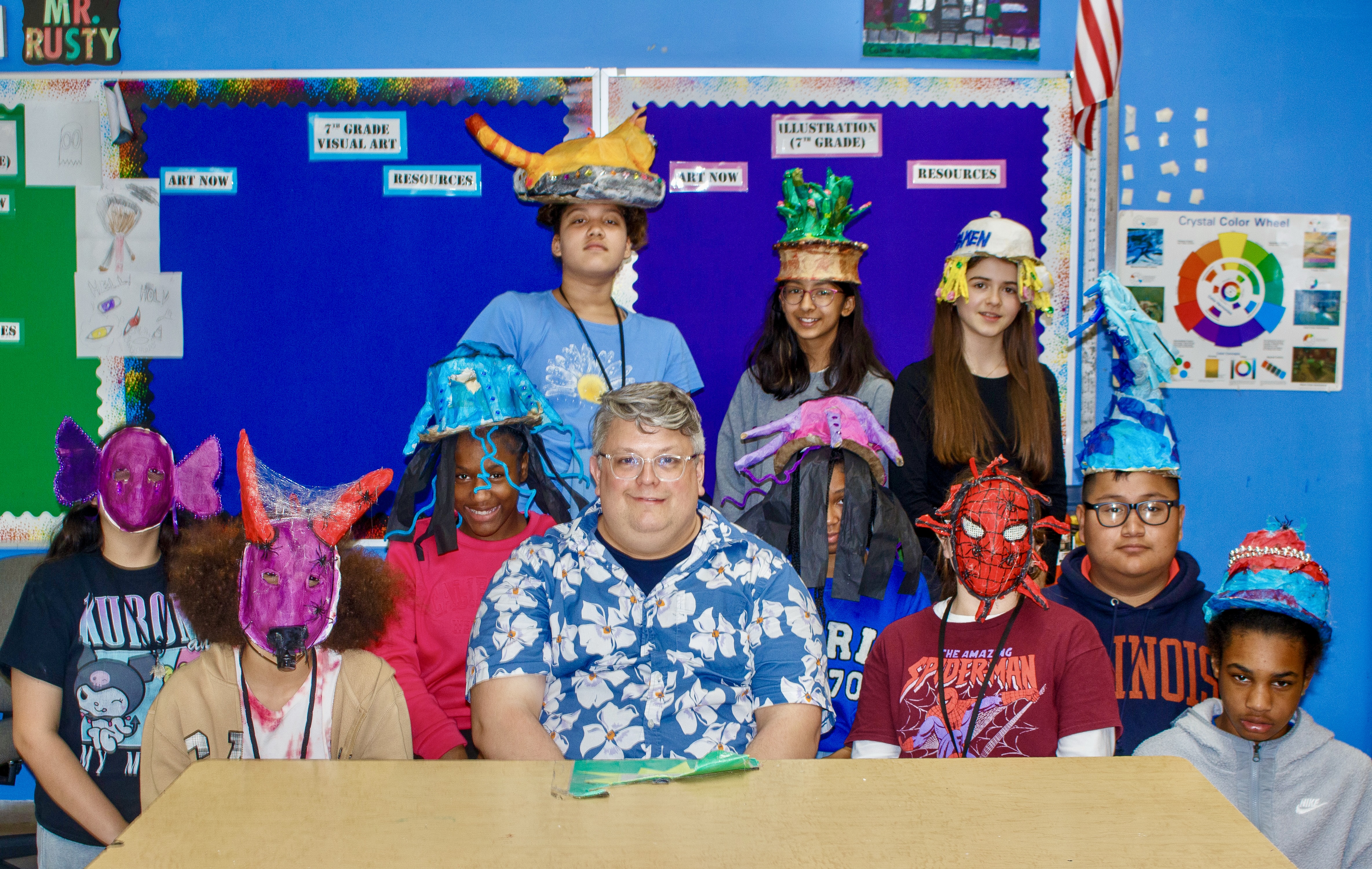 Rusty Clevenger and his art class. Students are wearing hats/masks that they created.